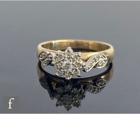 A 9ct diamond cluster ring, central claw set nine stone daisy cluster to scroll shoulders with further diamond details, weigh