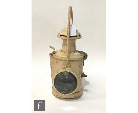 A locomotive head lamp painted white with fixed handle and bullseye glass, height 39cm. 