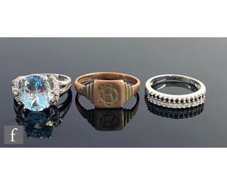 Two 9ct white gold stone set rings to include a blue topaz example, with a 9ct signet ring, total weight 10.4g. (3) 