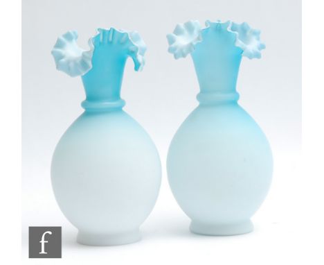 A pair of late 19th Century satin glass vases of footed ovoid form with collar neck and frilled tri-form rim, decorated in a 