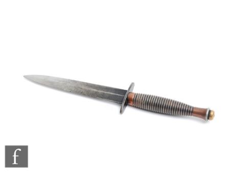 A Third Pattern Fairbairn-Sykes fighting knife, with a ribbed alloy grip and brass screw pommel, a 2 inch oval cross guard an