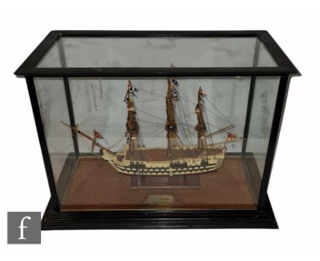 A 20th Century scale wooden model of HMS Victory, length 48cm, in ebonised display case 44cm x 58cm. 
