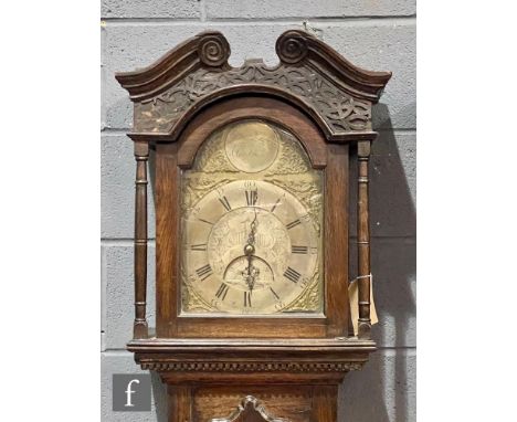 A late 18th Century oak longcase clock with a thirty-hour movement striking on a bell, the twin scroll hood with blind-fret f