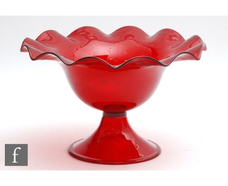 A large 20th Century continental ruby glass bowl with frilled rim and controlled air bubble pattern, raised to a hollow conic