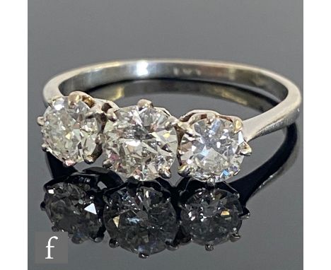 A platinum diamond three stone ring, transitional cut stones, total weight approximately 1.40ct, colour K/L, clarity I2, claw