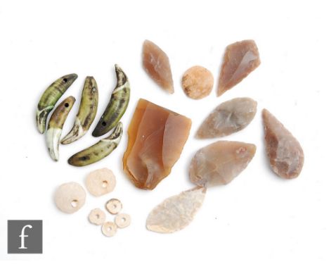 A collection of Neolithic arrow heads and beads and a small collection of wolf teeth pierced to form a necklace, possibly Vik