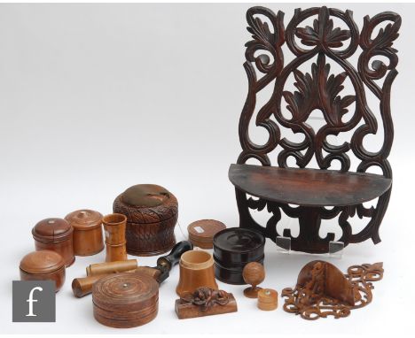 A collection of treen ware to include turned boxes, a roller and two wall brackets. (qty) 