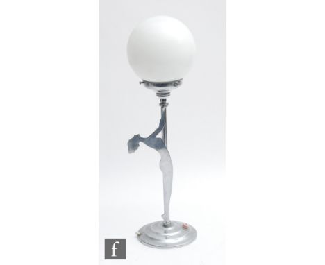 An Art Deco chrome table lamp of a nude silhouette figure holding a white globe, height 52cm. 