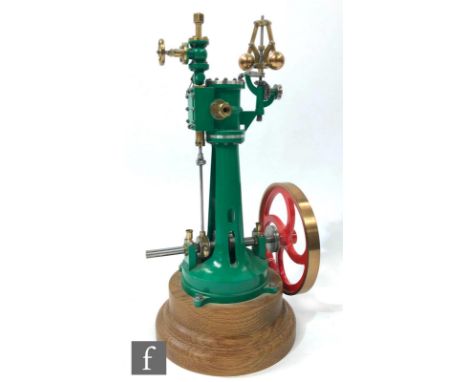 A vertical live steam engine with single oscillating cylinder and centrifugal governor, painted in green with red painted fou