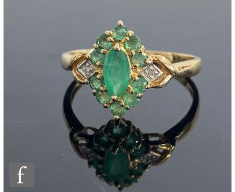 A 9ct hallmarked emerald and diamond cluster ring, central marquise emerald within a ten stone emerald border with diamond de