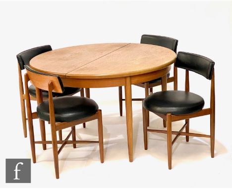 A G-Plan circular teak dining table, diameter 123cm, and a set of four black vinyl upholstered dining chairs. (5)   The chair