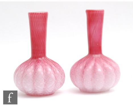 A pair of late 19th Century quilted satin air trap vases, each of lobed globe and shaft form, cased in a graduated pink over 