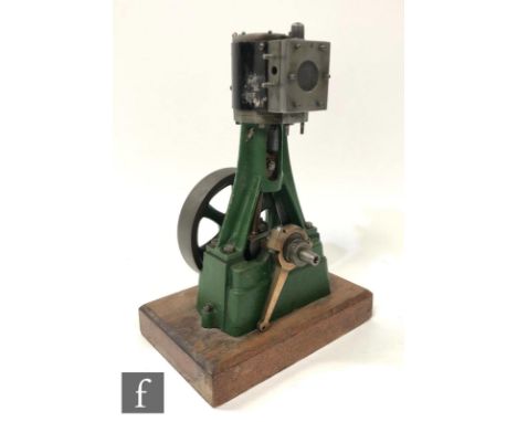 An incomplete single cylinder vertical engine, possibly Stuart, with six spoked flywheel, numbered 64 and painted in green, l