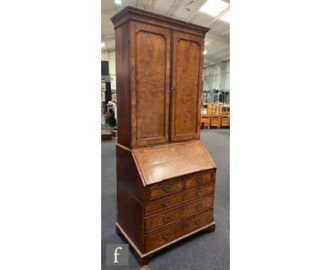 An early 18th Century crossbanded and feather banded walnut bureau bookcase, the shelf and drawer interior enclosed by a pair