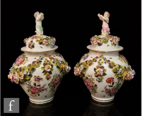 A pair of 20th Century vase and covers each decorated with garlands of encrusted flowers and foliage with painted floral spra