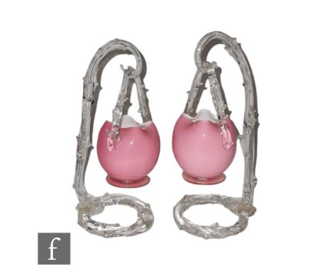 A pair of late 19th Century hanging posy vases, the footed posies in pink over opal with a clear crystal rustic form handle, 