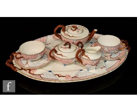 A late 19th Century Wedgwood Aesthetic cabaret tete-a-tete set comprising squat teapot, milk jug, sugar bowl and two cups and