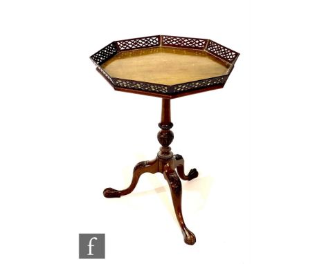A late 19th or early 20th Century octagonal mahogany occasional or silver table with pierced gallery border, on a turned carv