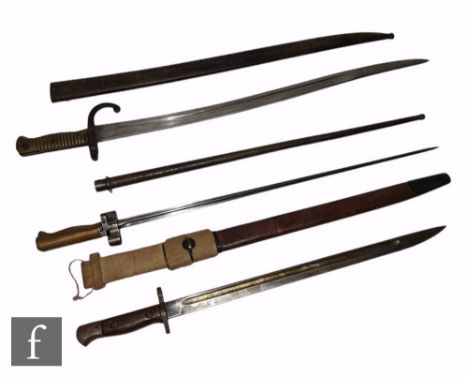 A 1907 British Sanderson pattern bayonet stamped Apman with leather scabbard and canvas frog, a French Lebel spike bayonet an