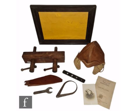 A World War One brown leather flying helmet, maker Morgan &amp; Taylor London W1, a framed piece of stitched fragment reputed