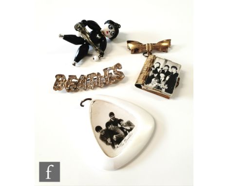 A small group of original 1960s Beatles memorabilia to include&nbsp;a gold coloured metal brooch modelled as a book with vari