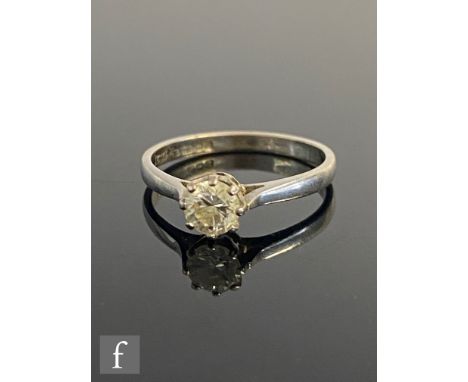 An 18ct white gold diamond solitaire ring, brilliant claw set stones, weight approximately 0.40ct, to knife edged shoulders, 