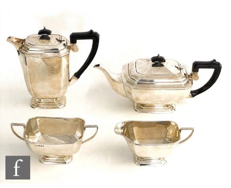 A hallmarked silver Art Deco four piece pedestal tea set of plain faceted boat shaped form, terminating in ebonised handles, 