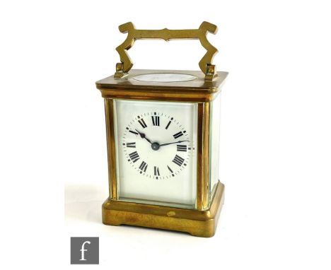 A 20th Century brass carriage clock, white enamelled dial on stepped base, height 10cm. 