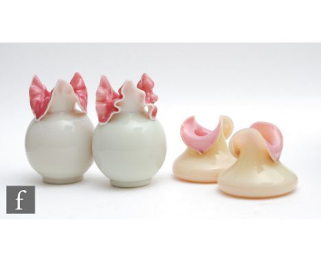 A pair of late 19th Century glass posy vases of ovoid form with a high pulled triform rim, cased in opal over deep pink, heig
