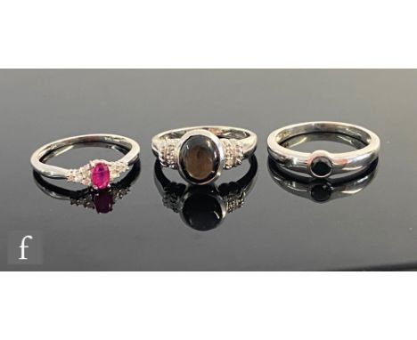 Three 9ct hallmarked 9ct white gold set rings to include hematite and ruby examples, total weight 7.7g, sizes M and N. (3) 
