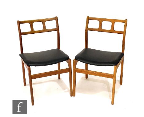 A set of six 1970s teak dining chairs, with pierced rail backs over black vinyl upholstered seats. (6) &lt;p&gt; The chairs i