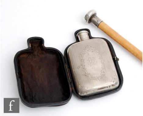 A Victorian gentleman’s engine turned silver hip flask, Birmingham 1872, in leather case, and a silver topped walking cane, l