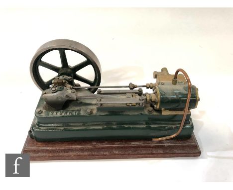 A Stuart single cylinder horizontal engine with six spoked flywheel, painted in green, loose on base, length 23cm. 
