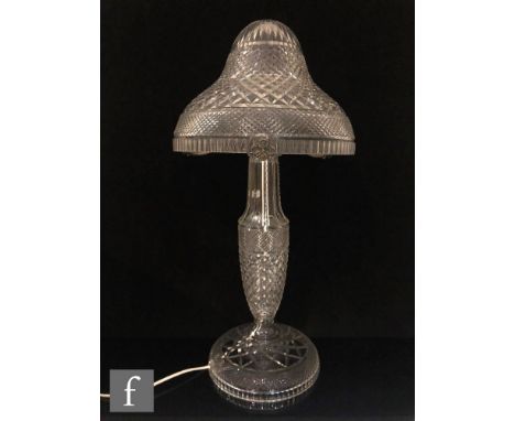 A large early 20th Century clear cut crystal table lamp, the domed base rising to a slender baluster form column with gallery
