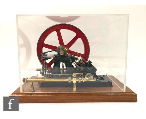 A single cylinder diagonal oscillating engine with six spoked flywheel, diameter 18.5cm, professionally finished and raised t