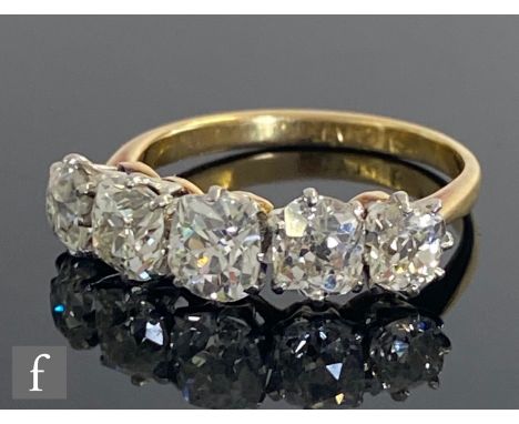 An 18ct diamond five stone ring, graduated claw set old cut stones, total weight approximately 2.40ct, claw set to knife edge