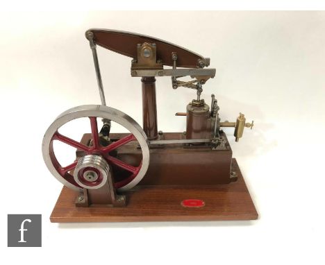 A Stuart live steam single cylinder beam engine, painted in brown with six spoked red flywheel, shown at the Midlands Model E