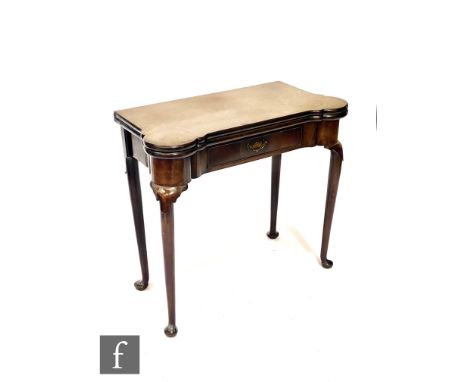 A George III mahogany card table, the shaped top opening to reveal a dished sectioned interior, single frieze drawer, on slen