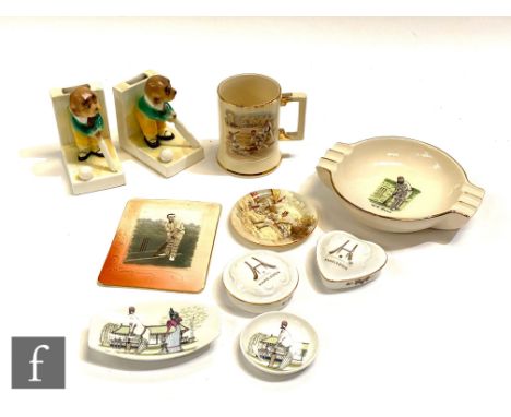 A cigarette or cigar dish with transfer printed scene of W G Grace, a pair of figurative bookends playing cricket, a transfer