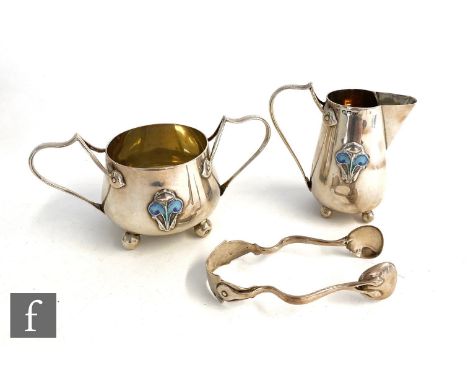 An Art Nouveau hallmarked silver strawberry set comprising cream jug, height 8cm, and twin handled sugar basin each with blue