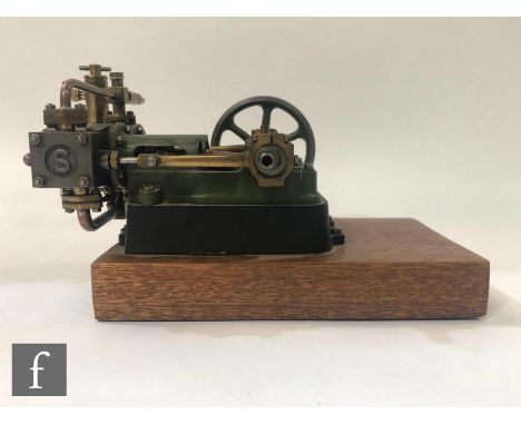 A Stuart live steam twin horizontal mill engine with two cylinders and a six spoked flywheel, painted in green and raised to 