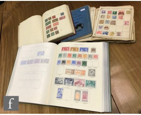 A King George VI green world stamp album containing all mounted mint Commonwealth stamps and three old world stamp albums. (4