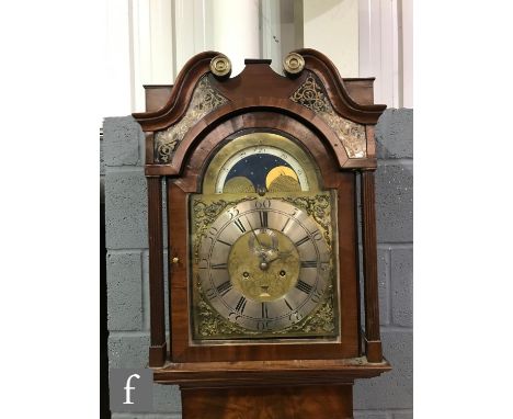 A George III mahogany longcase clock with a later associated eight-day movement striking on a bell, the hood with twin scroll