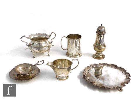 Six hallmarked silver items to include a small modern card waiter, a sugar basin, a small tankard, a sugar caster, a tea stra