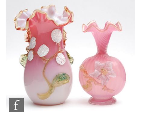 A late 19th Century cased body vase of swollen ovoid form with trim form neck, cased in pink over opal with an applied amber 