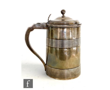 A George III hallmarked silver cylindrical tankard detailed with two reeded bands, scroll handle with acanthus leaf thumb pie