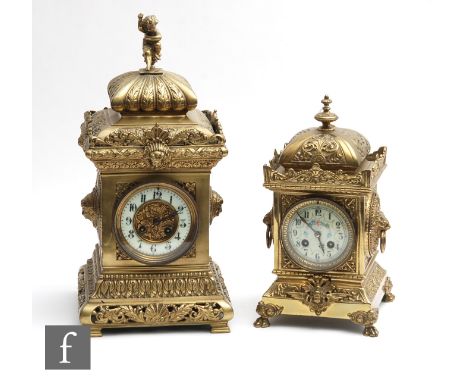 An Edwardian brass cased mantle clock with eight day striking movement, circular Arabic dial, the top surmounted with a cheru