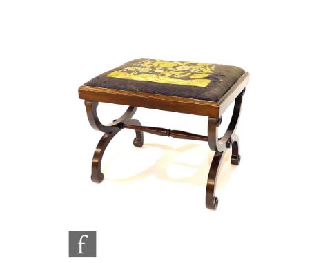 An Edwardian mahogany stool with tapestry slip in top on swept cross end supports united by a turned stretcher, width 56cm. 