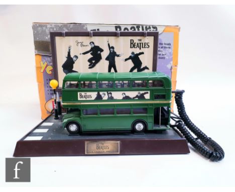 A vintage Beatles collection telephone, the original 1998 Apple licensed novelty telephone in the form of a routemaster bus, 