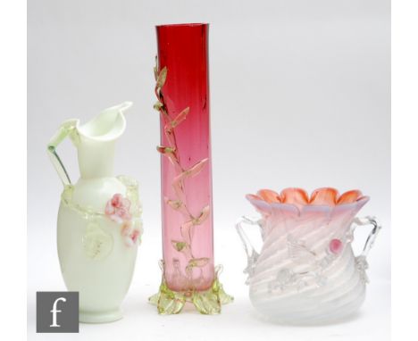 A late 19th Century posy vase with wrythen fluted opalescent spirals beneath a petal edged rim with graduated cranberry tint,